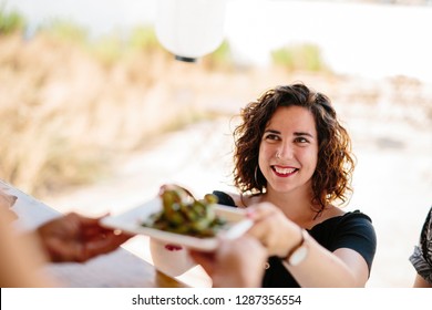 From above shot of smiling woman taking plate with food from vendor in food truck outdoors - Powered by Shutterstock