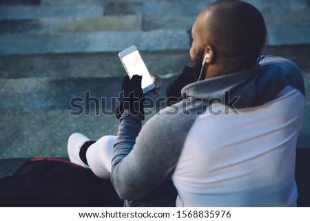 Similar – Attractive black man listening to music with earphones