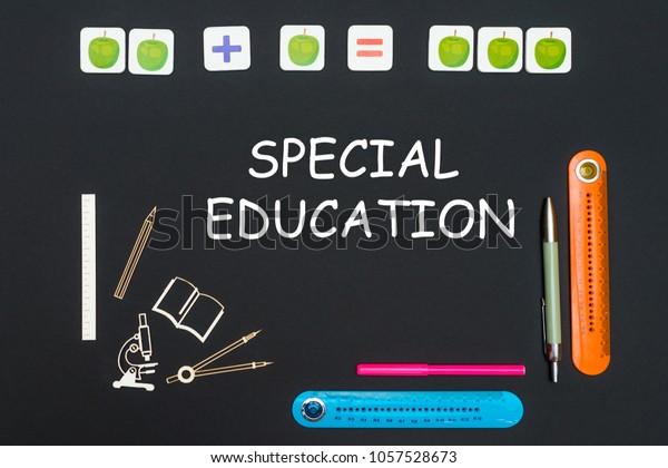 Above stationery supplies and text\
special education on black background, education\
concept