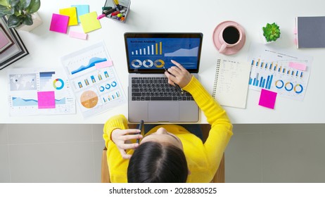 Above top desk of SME owner people home office call talk in SEO chart sale report paper or stock graph big data. Woman remote study MBA digital learn online of job career reskill upskill work plan.