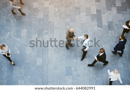 Similar – Image, Stock Photo Two young men shake hands. Close up of the hands in front of a green background.