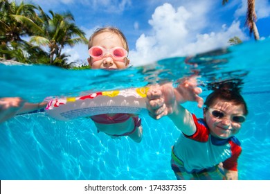 Above And Underwater Photo Of Kids Swimming In Pool