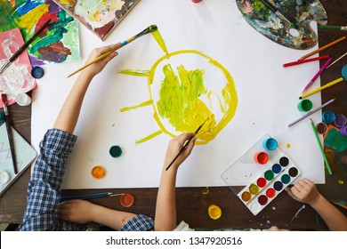 Above View Background Of Two Children Drawing Sun While Painting Picture Together, Copy Space