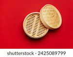 Above view with a bamboo steamer minimalist on a red colored table