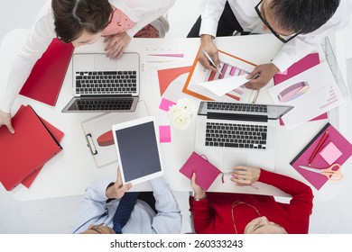 Above View Of Business Team Sitting Around Table And Working