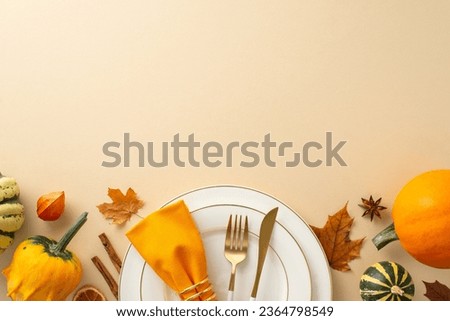 Above view captures essence of family Thanksgiving dinner with gilded tableware, classic cutlery, and autumnal decorations rest on a beige isolated background, inviting text or promotional content