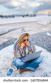 Above View Of Cheerful Beautiful Adult Woman Using Laptop Computer Sitting On The Ground In The City - Concept Of Modern Happy People With Roaming Technology - Travel Female And Digital Nomad Job