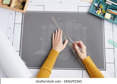 Above View Close Up Of Female Architect Drawing Blueprints And Plans While Sitting At Desk In Office, Copy Space