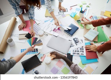 Above view closeup of creative business team brainstorming design ideas over table, copy space - Powered by Shutterstock