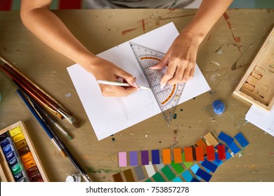 Above View Closeup Of Unrecognizable Young Woman Drafting Sketch With Pencil For Art And Craft Project Sitting At Wooden Table In Workshop