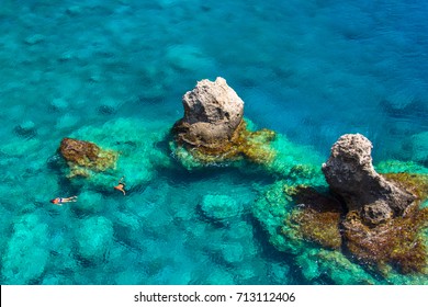 Above View Of Couple Snorkeling In Turquoise Sea Water, Glyka Nera, Chania, Crete, Greece