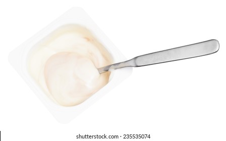 Above View Of Creamy Yogurt And Spoon In Disposable Plastic Cup Isolated On White Background