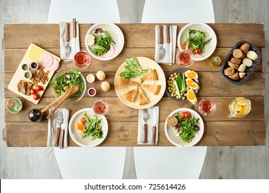 Above View Of Dinner Table With Delicious Food Set For Four In Cafe Or Restaurant