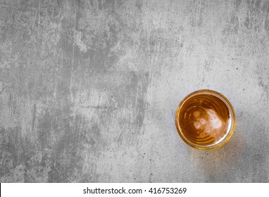 Above view of a glass of beer on gray concrete table