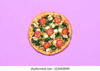 Above View With A Homemade Vegetarian Pizza On A Purple Table. Freshly Baked Pizza Made With Feta Cheese, Spinach, And Tomatoes.