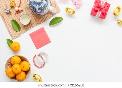 Above view image shot of accessories on Lunar New Year & Chinese New Year holiday background concept.free space for mock up & Template.Mix objects on modern design white wooden at home office desk.