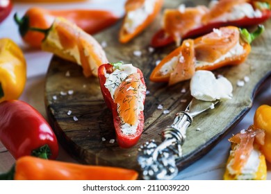 Above view of Keto sushi, smoked salmon and cream cheese stuffed mini sweet peppers, with dried dill weed. Selective focus with blurred foreground and background. 