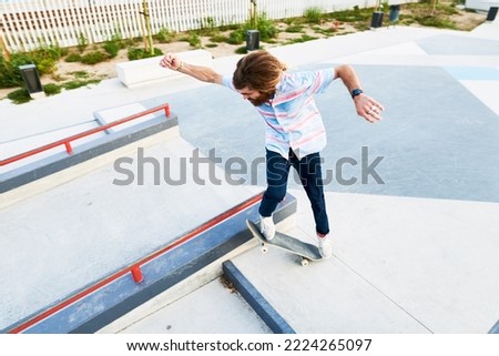 Similar – Image, Stock Photo Young bearded skater performing trick in skatepark