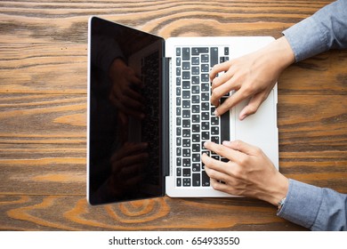 Above View Of Male Hands Using Laptop At Table