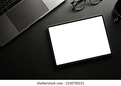 Above View, Modern Minimal Black Workspace With Laptop Computer, Eyeglasses And Digital Tablet White Screen Mockup.