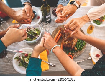 Above View On Hands Holding Together In Pray Over The Thanksgiving Meal. Family Thankful For The Food. Praying Grace Before Festive Dinner