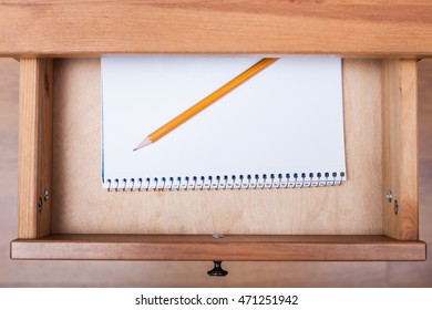 above view of pencil on artistic album in open drawer of nightstand - Shutterstock ID 471251942