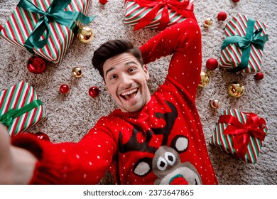 Above view photo of cheerful nice person take selfie laying carpet floor festive giftbox tree toys enjoy magic spirit house indoors