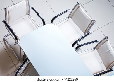 Above view of plastic table with several chairs near by