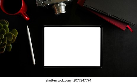 Above view, portable touchpad, tablet blank screen mockup and accessories on black background. photo editor workspace. flat lay, top view