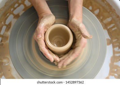 Above view of process of making clay pot on potter's wheel - Powered by Shutterstock