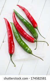 Above View Of Red And Green Chili Peppers, White Wooden Surface