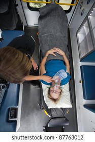 Above View Of Senior Woman In Ambulance With EMT Worker