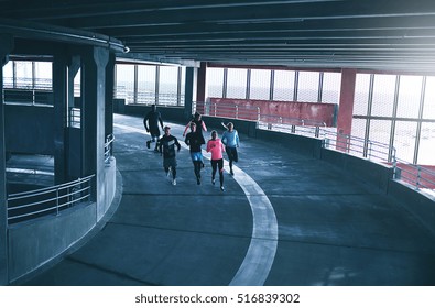 From above view of several athletes running in parking building. Copyspace  - Powered by Shutterstock