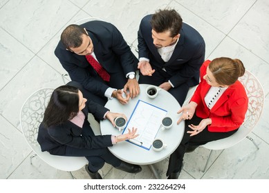 Above View Of Several Business People Are Planning Work At Round Table.