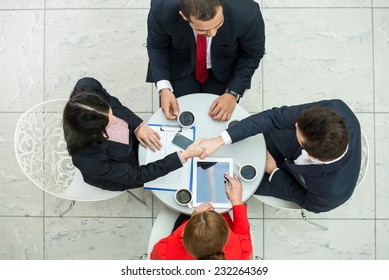 Above View Of Several Business People Are Planning Work At Round Table.