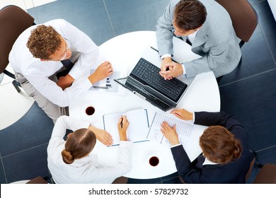 Above View Of Several Business People Planning Work At Round Table