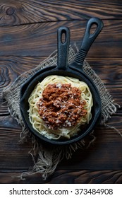 Above View Of Spaghetti Bolognese In A Rustic Wooden Setting