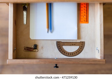 above view of stationery set in open drawer of nightstand - Shutterstock ID 471259130