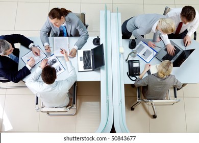 Above View Of Two Groups Of People Discussing At A Meeting