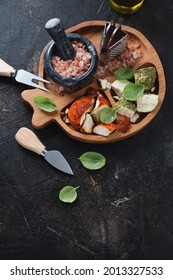 Above View Of A Wooden Serving Tray With Swiss Belper Knolle, Cheese Knives And Grater, Vertical Shot On A Dark Brown Stone Background With Space