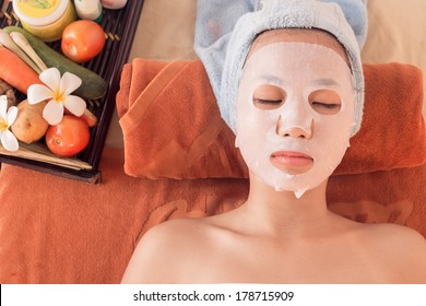 Above view of a young woman in a spa making face mask treatment