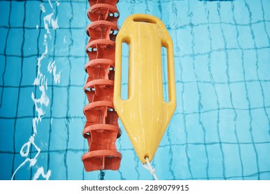 Above, water and a buoy in a pool for safety, life saving and floating help. Board, summer and equipment for protection, security and danger while swimming, rescuing and protecting from drowning - Powered by Shutterstock