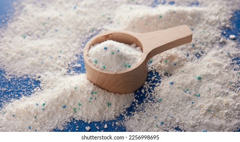 From above of white washing powder for daily hygiene routine in wooden measuring cup placed on table in light room - Shutterstock ID 2256998695