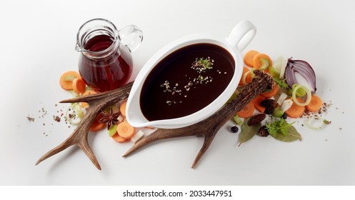 From Above Of Worcestershire Sauce In White Porcelain Gravy Boat Placed On Table With Vinegar Cruet And Various Fresh Cut Vegetables