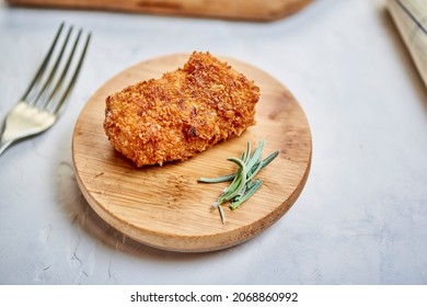 From Above Yummy Chicken Nugget And Aromatic Rosemary Served On Wooden Plate Near Fork On Gray Table