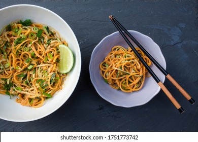 Aboveview Of Thai Peanut Noodles In Bowls With Chopstick