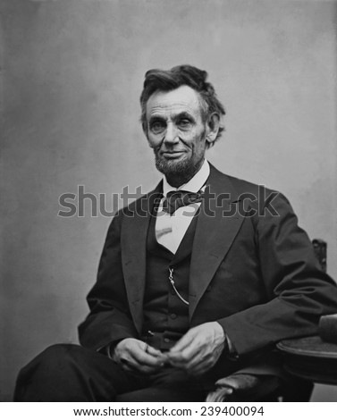 Abraham Lincoln (1809-1865) seated and holding his spectacles and a pencil on Feb. 5, 1865 in portrait by Alexander Gardner.