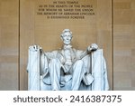 Abraham Lincoln seated in an armchair in the temple and monument in his honor on the National Mall in Washington DC, USA.