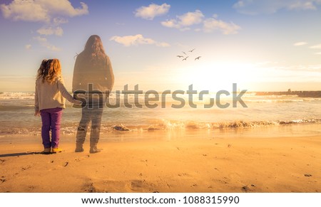 Absence. A girl holds the hand of the spirit of her deceased mother. The two are watching the sunset.