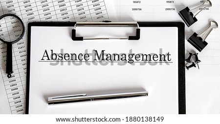 ABSENCE management written on the paper with office tools